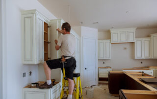 Man installing kitchen cabinets door