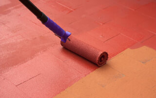 Contract painter painting a floor on color red